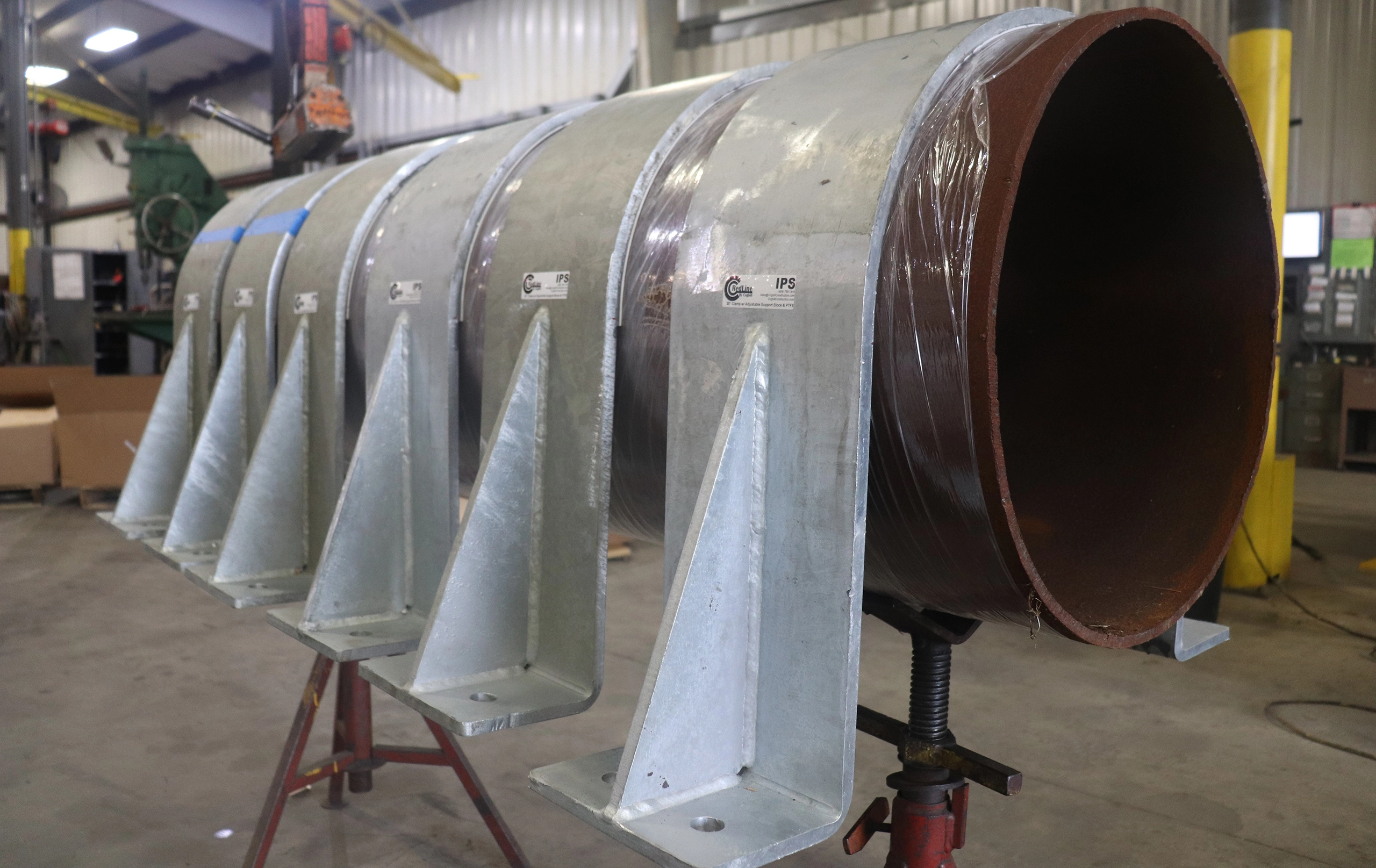 30-inch RedLineIPS hold-down clamps on a large pipe during the production phase.