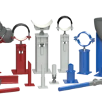 A collection of industrial pipe supports in red, white, and blue, including clamps, adjustable bases, and pipe elbows, displayed on a black background.